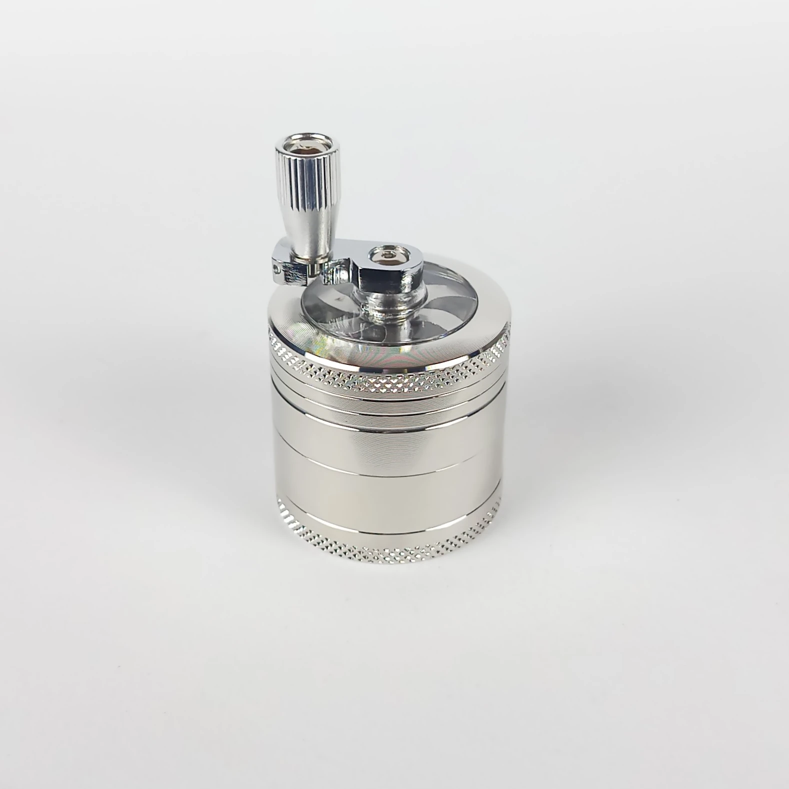 Crusher Mill Champ Mini 40mm – compact silver metal grinder with crank handle, designed for smooth herb grinding and easy use.